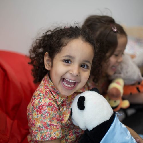 girl holding a panda toy