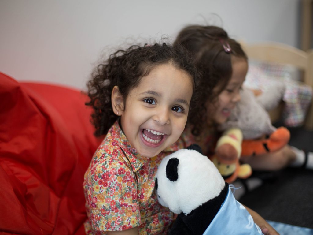 girl holding a panda