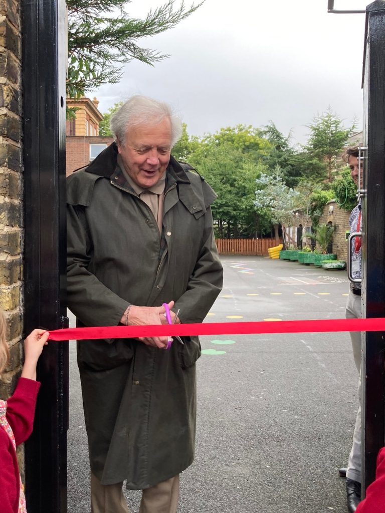 man cutting a ribbon