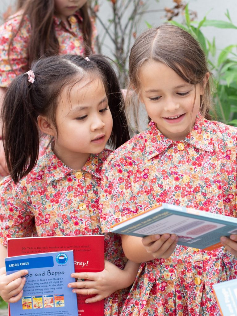 girls looking at picture books