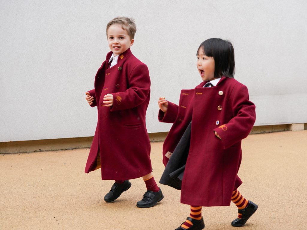 2 students in red coats