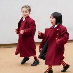 2 students in red coats