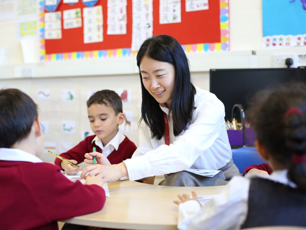 students and a teacher on the table