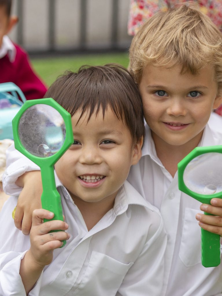 students with magnifying glasses