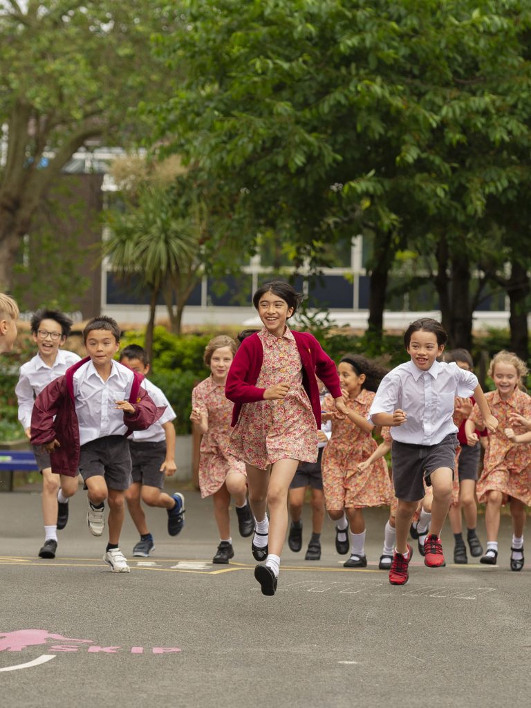 students running across the playground