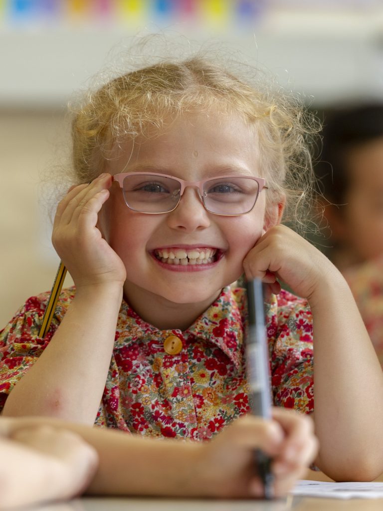 smiling student wearing glasses