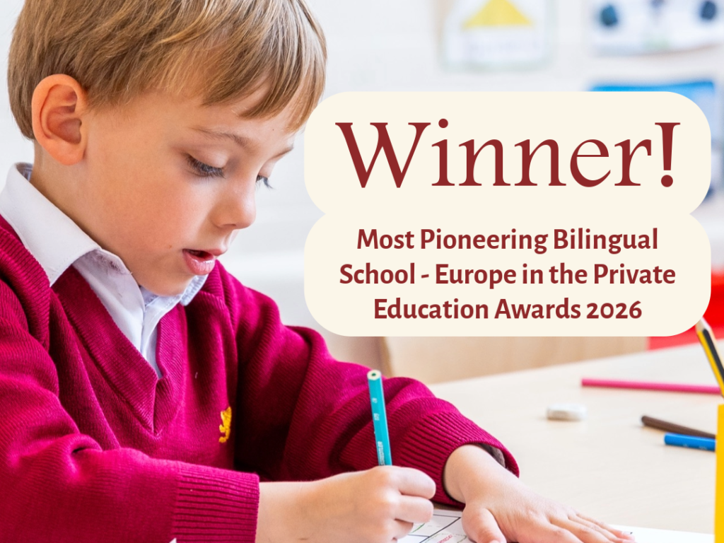 A young student in a maroon sweater writes at a desk while a speech-bubble banner announces 'Winner! Most Pioneering Bilingual School ... Education Awards 2026'